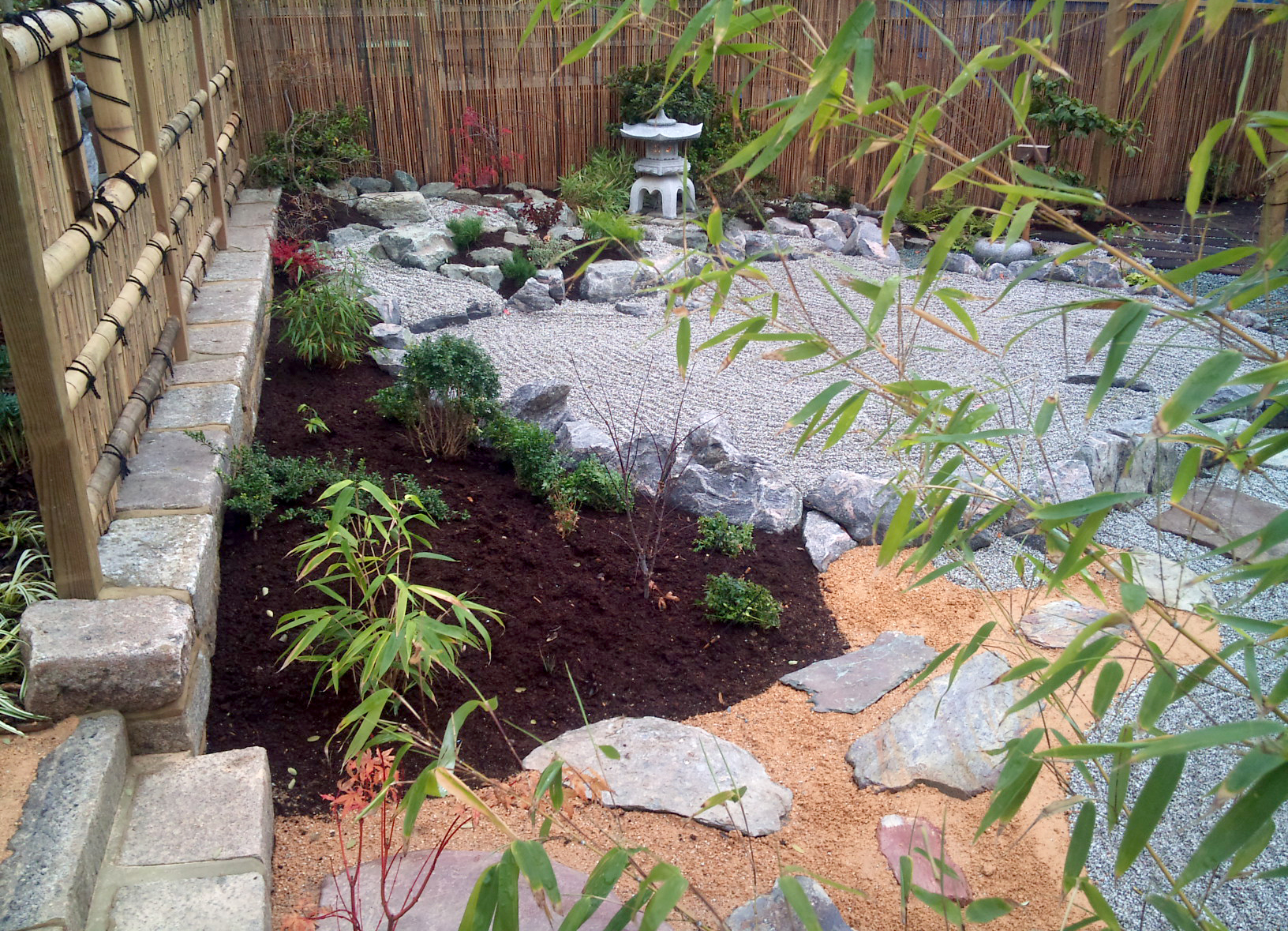 Japanese garden with dry riverand bamboo plantings around tea temple sculpture